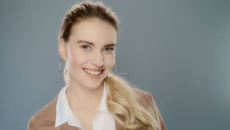 happy business woman showing ok gesture in studio