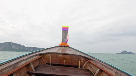 boat travels through ocean towards distant islands