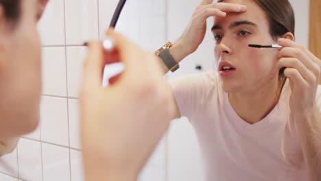 caucasian non-binary transgender woman doing make up