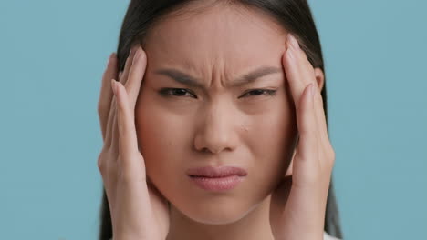 young asian woman suffering from a headache and stress