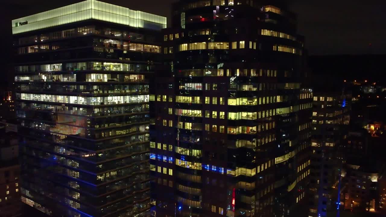 Aerial view of illuminated skyscraper offices at night in downtown Montreal, Canada