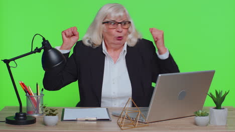 senior office businesswoman showing biceps, looking confident, feeling power strength to success win