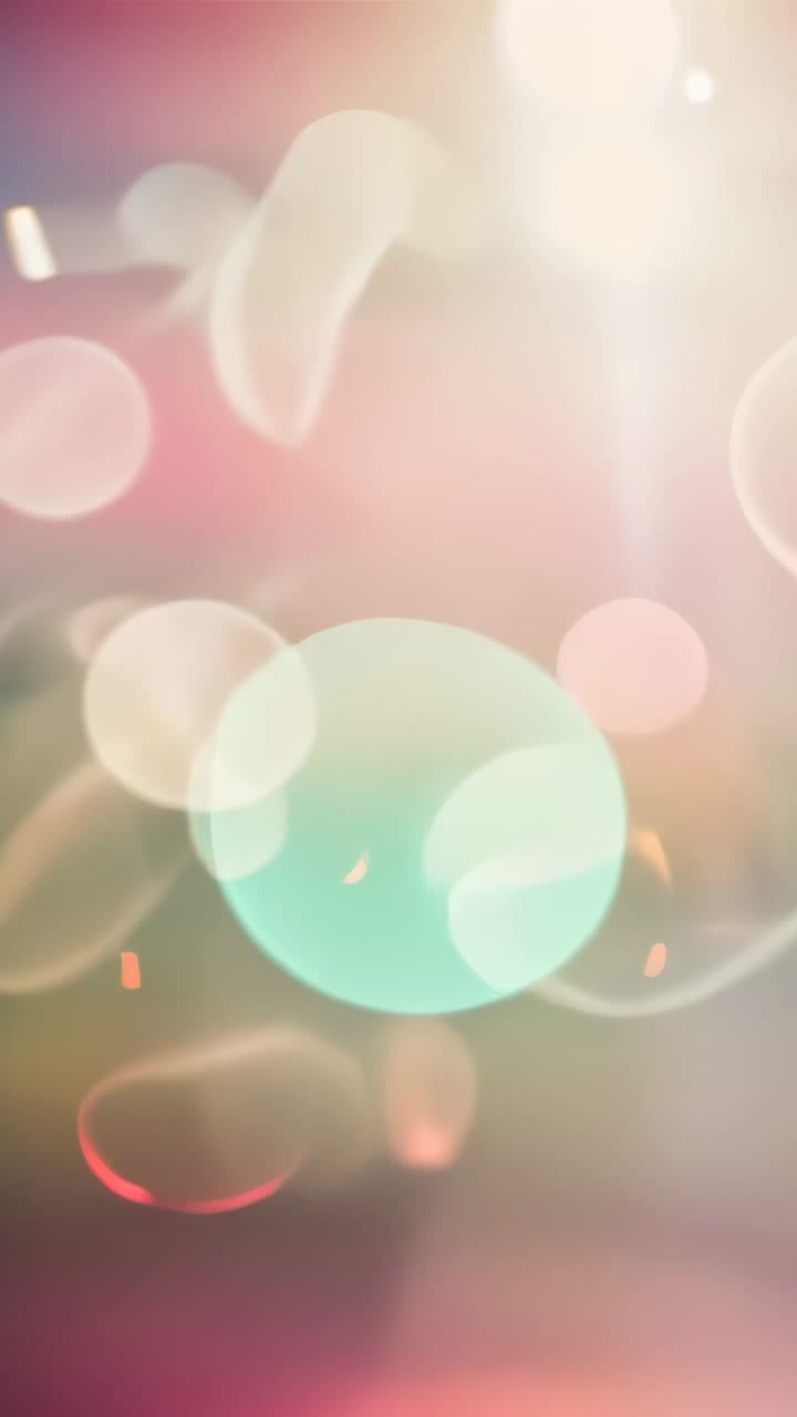 Vertical video: Drifting orbs and rings on pastel scene, top beam growing, teal orb sending sparks
