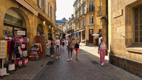 people shopping and walking in a sunny market