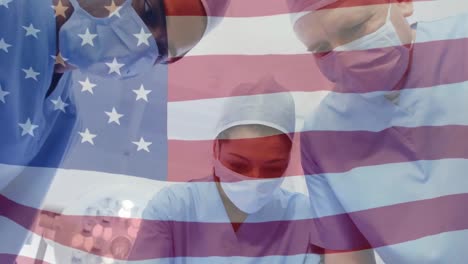 Animation-of-flag-of-usa-waving-over-surgeons-in-operating-theatre