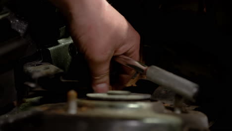man maintenance of his car in a garage