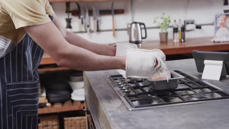 Hombre-Caucásico-Sacando-Pan-Del-Horno-En-La-Cocina,-Cámara-Lenta