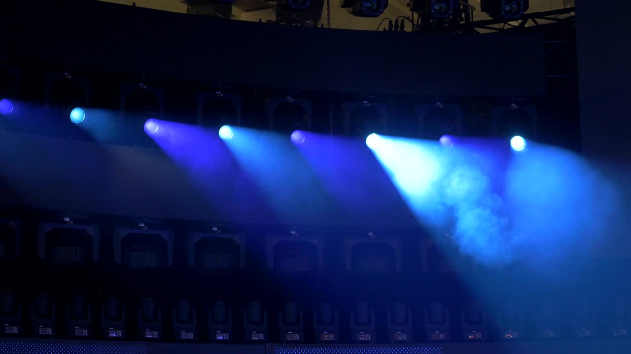 Row of Beam Lights Glowing Red, Blue, and Orange
