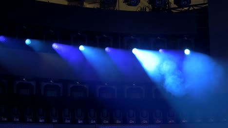 row of beam lights glowing red, blue, and orange