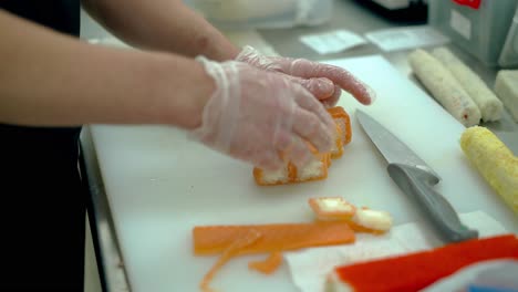 el cocinero sirve un rollo japonés con salmón.