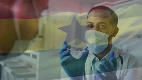 Animation-of-flag-of-ghana-with-male-doctor-in-face-mask-showing-covid-vaccine-to-patient