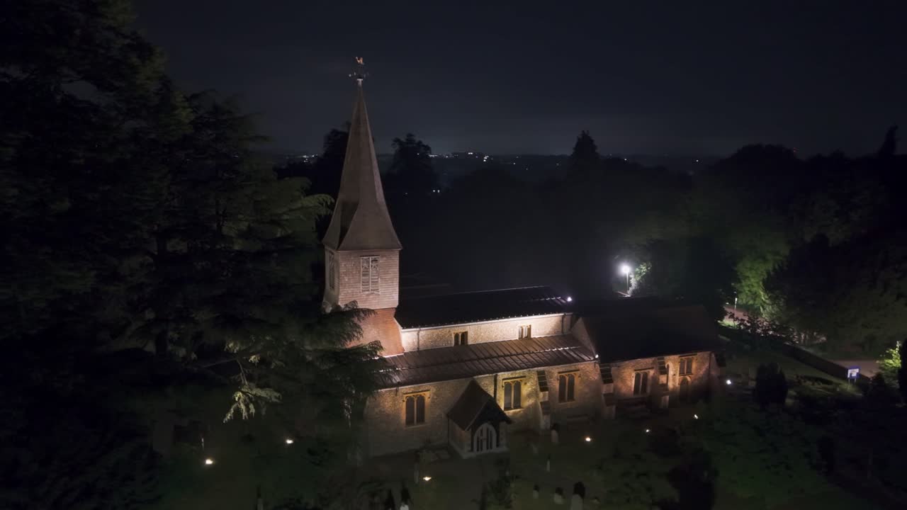 A stunning drone orbit at night showcasing St Michael’s Church in St Albans, England, beautifully lit with warm lights highlighting its historic architecture
