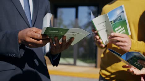 real estate agents reading brochures