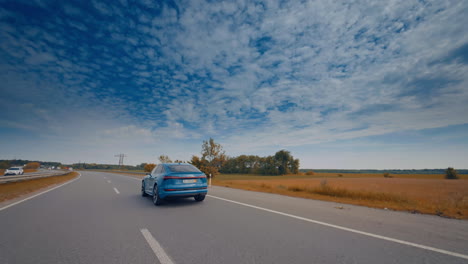 modern electric car on the road with blue sky. luxury comfortable ecology electric vehicle on the road.