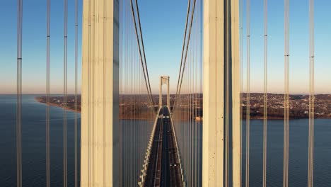 traffic on the verrazzano-narrows bridge, golden hour in ny, usa - descending, aerial view