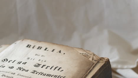 upward tilt of ancient bible in swedish with brownish crinkly pages