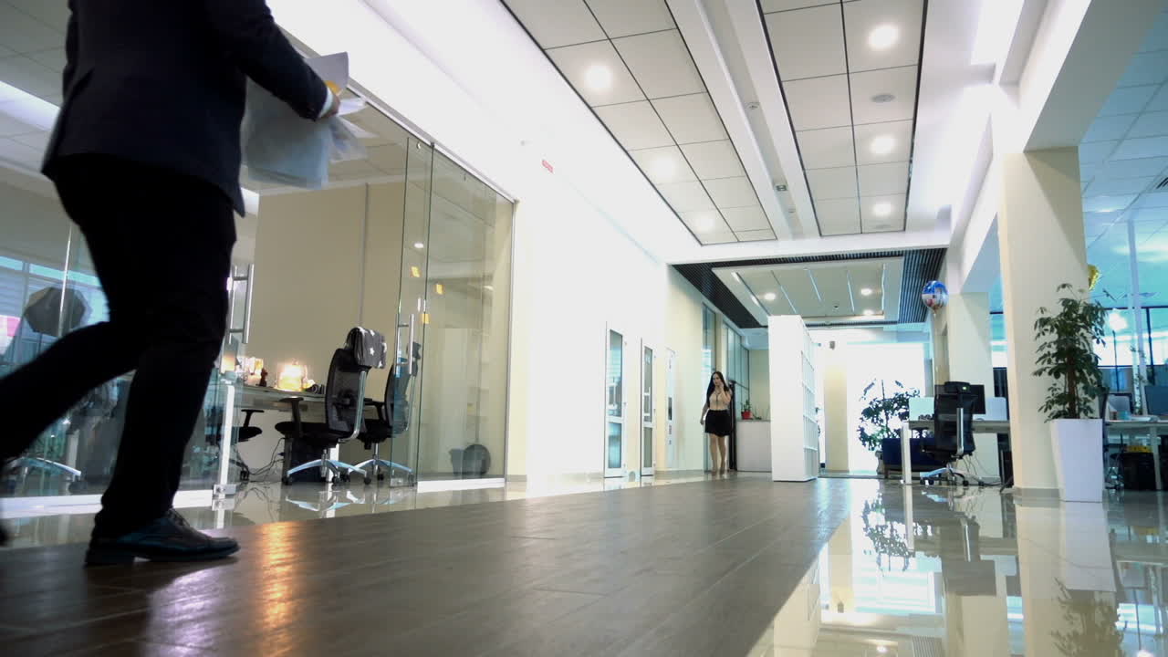 Business Man Celebrating Success. Happy businessman throwing document while goes through the hall of the office