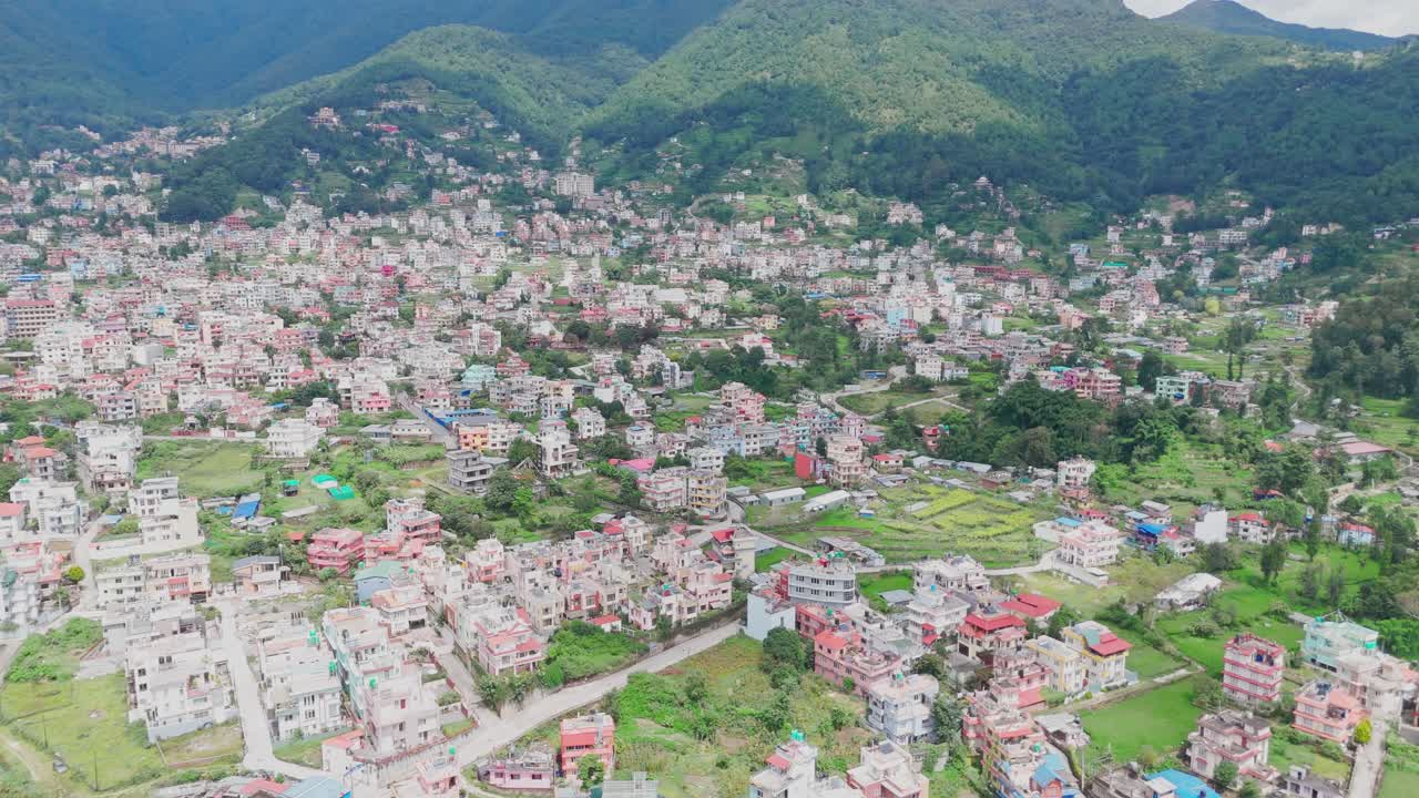 Aerial drone footage of Budhanilkantha in Kathmandu Valley, Nepal, showcasing city settlements, green hills, and scenic mountain landscapes from above