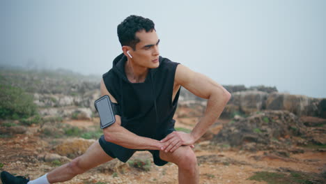 trail runner prepare workout in nature park closeup. focused athlete stretching