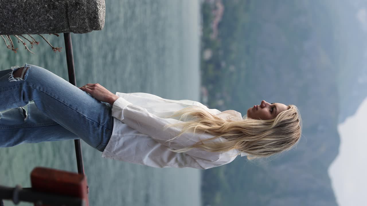 красивая блондинка женщина турист путешествует на живописном озере комо, италия - вертикаль