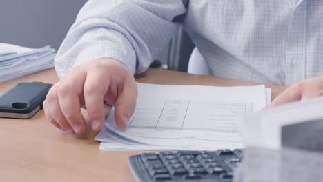 businessman reviewing documents at his desk