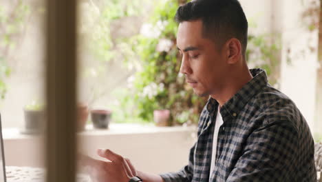 man texting on smartphone, working alone