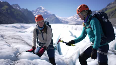 a climber navigates a stunning glacier landscape, showcasing skills with an ice axe against a backdrop of towering peaks and clear skies. adventure and exploration await in this remote location.