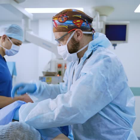 team of surgeons performing operation in bright modern surgery room. operating theatre. modern equipment in clinic.