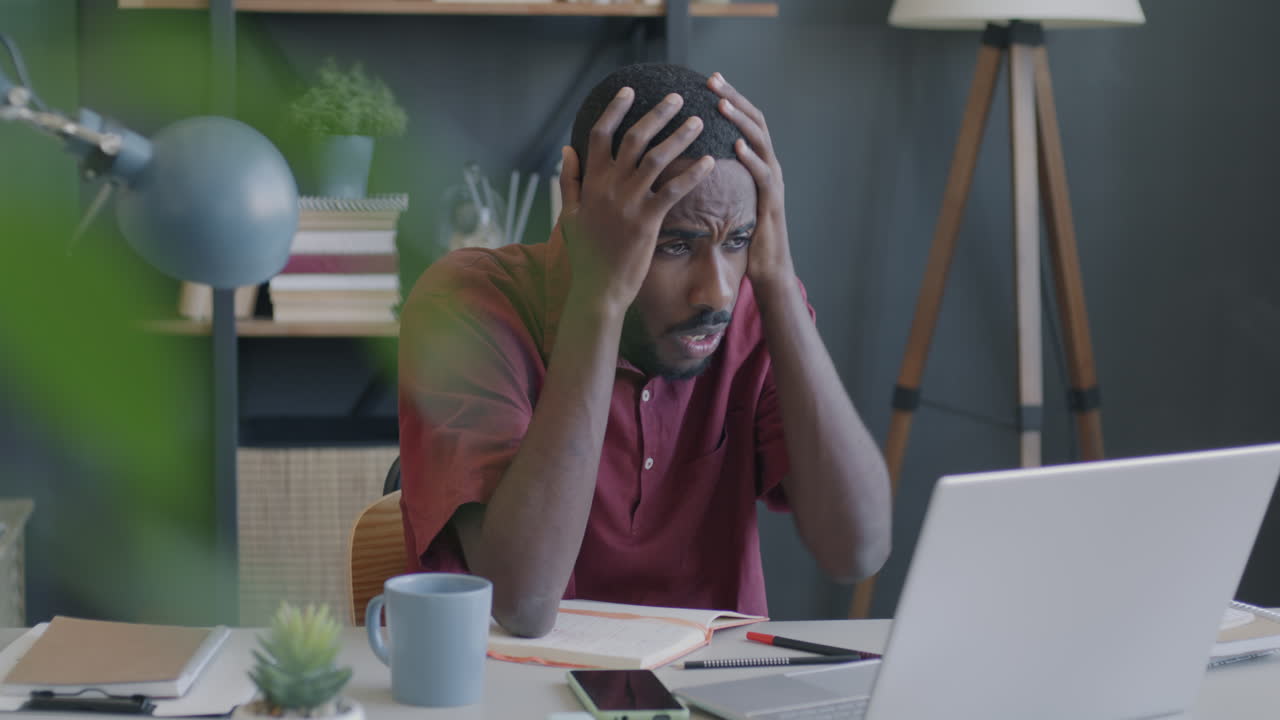 Man Stressed While Working on Laptop