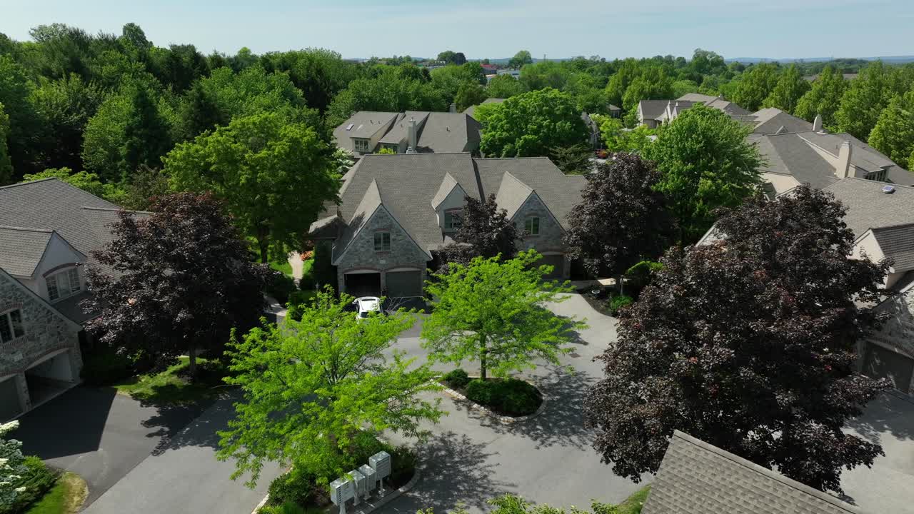 Drone view of a private retirement community of townhouses and duplexes on a bright summer day
