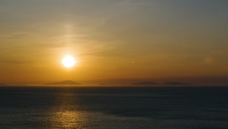 Golden-sunset-over-tranquil-sea,-Isle-of-Skye