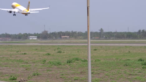 the atmosphere of the runway at yogyakarta international airport, a flyscoot commercial aircraft is seen taking off.
