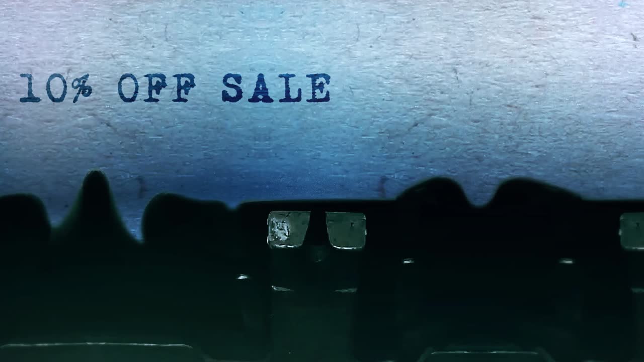 10 off sale word closeup being typing and centered on a sheet of paper on old vintage typewriter