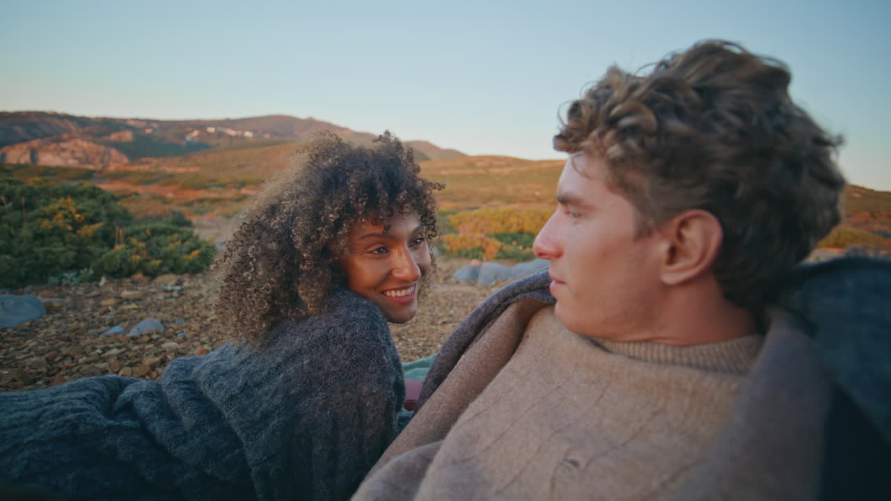 Romantic couple flirting sunrise hills picnic closeup. Joyful woman man flirting