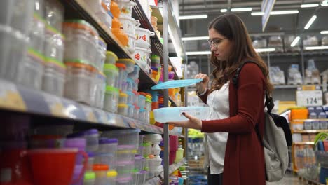 woman shopping for food containers in a grocery store