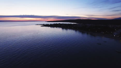 Clip-Aéreo-De-La-Costa-Croata-Durante-Las-Horas-Del-Atardecer,-Con-Una-Ciudad-En-El-Marco