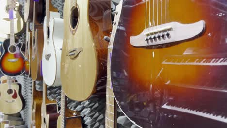 closeup of a man enthusiastically playing chords on an acoustic guitar.