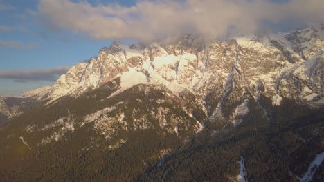 Aerial-view-across-cloudy-weather-covering-snowy-Zugspitze-glacial-mountain-summit