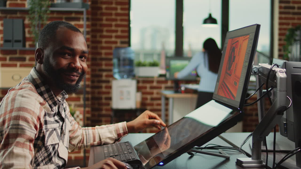 Creative office worker sitting at computer and creating digital art
