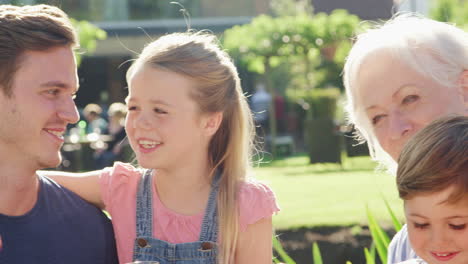 multi generation family enjoying outdoor summer drink at pub