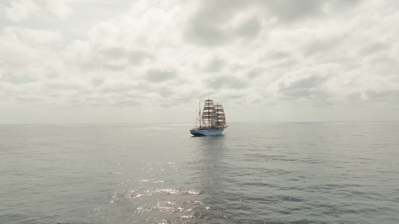 Sea cloud luxury cruise ship sailing vessel in the Atlantic Ocean under cloudy sky, Aerial pullback shot