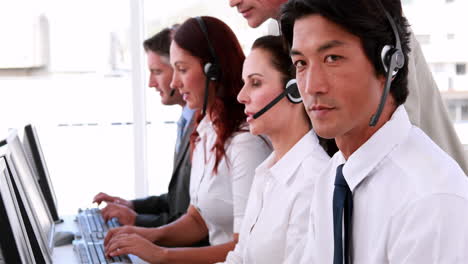 call centre agents working and talking on headsets