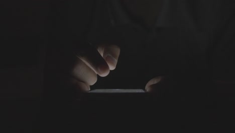 person using a smartphone in the dark