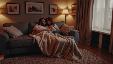 couple relaxing on sofa at home