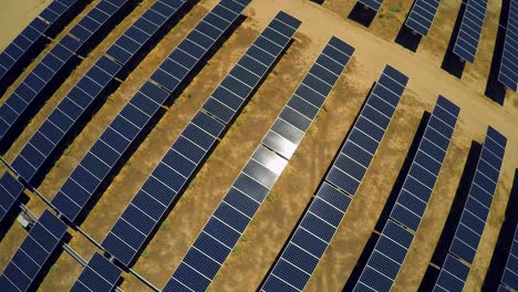 aerial over a vast solar array farm in the california desert 5