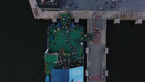 aerial drone shot of people leaving the ferry