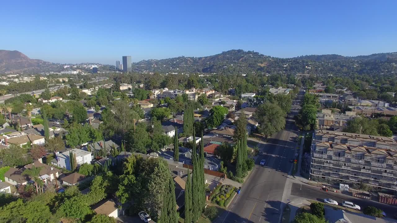 Drone Aerial Footage of Studio City California.  Sweeping sky to street move. 4K 23.98FPS