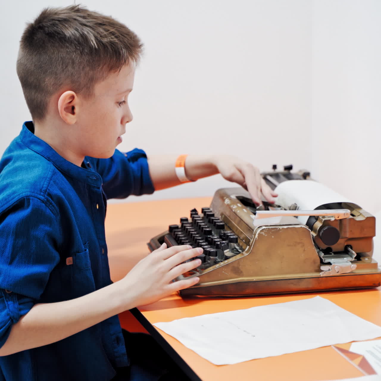 Little boy with the old typewriter, close up