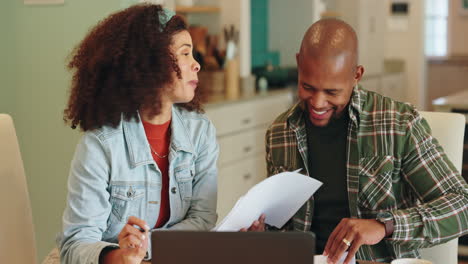 couple working from home on their finances