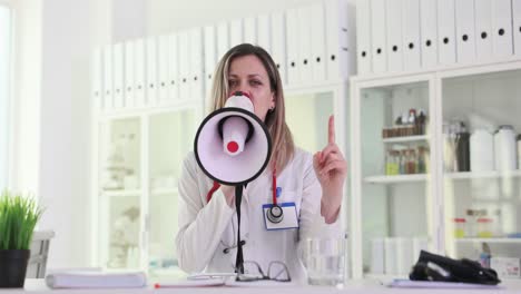 female doctor making an announcement with a megaphone in a clinic